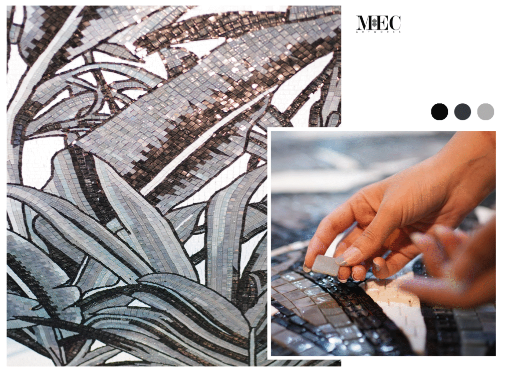Black and silver botanical mosaic being handcrafted with precision tiles, showcasing modern monochrome craftsmanship.