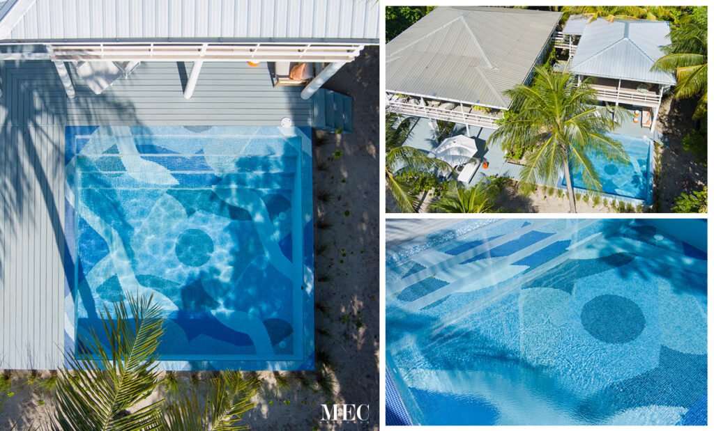 Beachside villa pool featuring abstract blue mosaic tile design, blending artistic patterns with tropical surroundings.