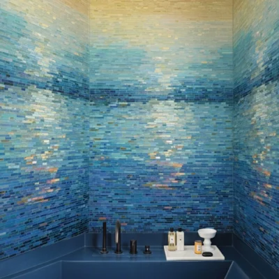 Golden and ocean blue mosaic tiles forming a sunset reflection pattern, perfect for luxury spa and bathroom interiors.