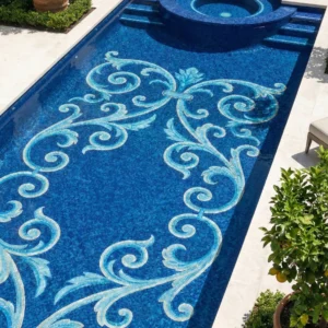 Blue pool mosaic with symmetrical scroll pattern in aqua and white, classic ornamental design on deep blue tiled pool floor.