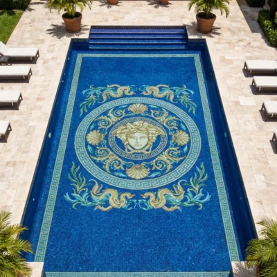 Luxury outdoor pool with deep blue Medusa mosaic, seashell and wave details, Greek key border, surrounded by palm trees and villa seating.