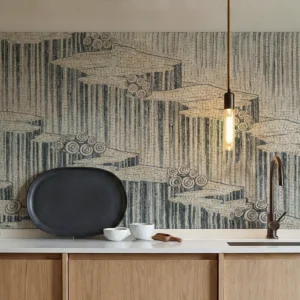Monochrome layered mosaic backsplash with architectural horizontal formations in a modern kitchen.