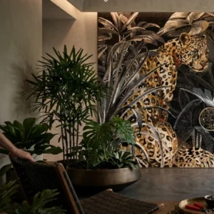 Luxury jungle leopard mosaic mural surrounded by tropical foliage in a sophisticated living space.