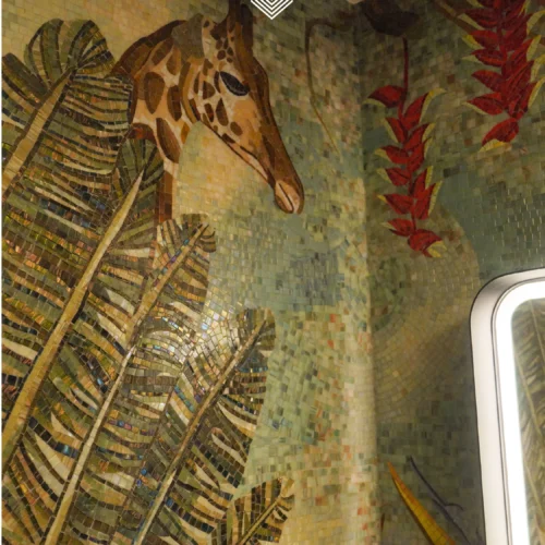 Giraffe mosaic mural with tropical leaves and warm tones wrapping a luxury bathroom corner.