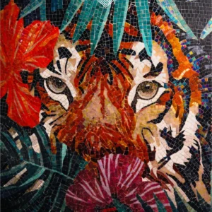 Colorful tiger face mosaic mural with tropical leaves and red flowers on a dark background.