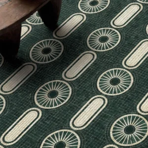 Emerald green mosaic floor with circular and oval geometric patterns in ivory tones.