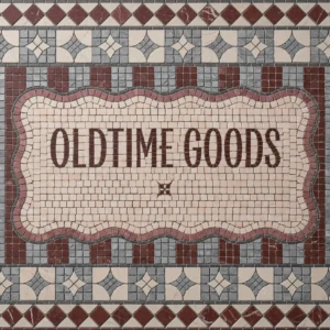 Vintage-style mosaic tile panel with “Old Time Goods” text and decorative geometric border.