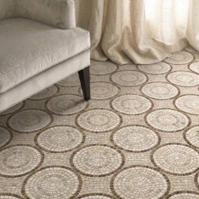 Mosaic floor with repeating circular medallion pattern in warm beige and taupe tones.