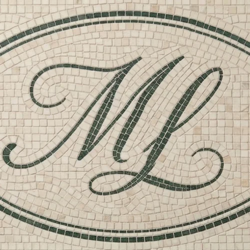 Custom mosaic tile panel with script monogram, “ESTD” and year, framed in decorative cartouche.