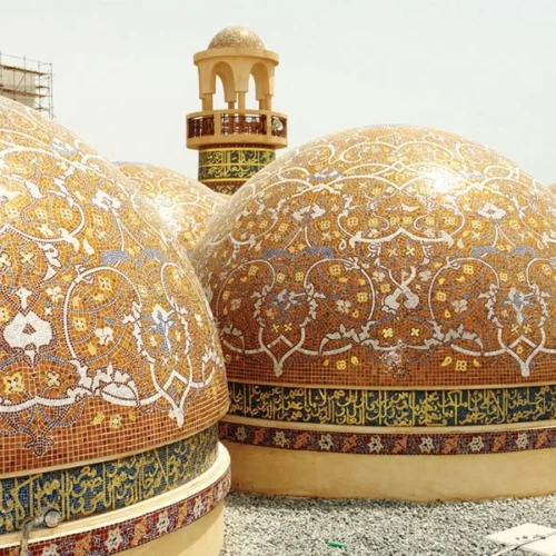 Golden Islamic dome mosaic with intricate arabesque patterns, floral motifs and Arabic calligraphy band inspired by traditional mosque architecture.