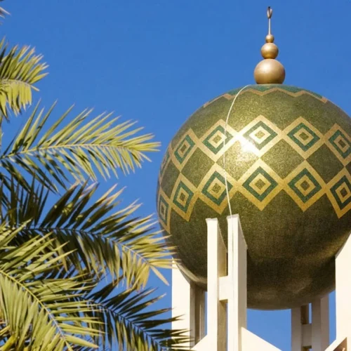 Green and gold Islamic dome mosaic featuring geometric diamond patterns inspired by traditional mosque architecture and modern Islamic design aesthetics.