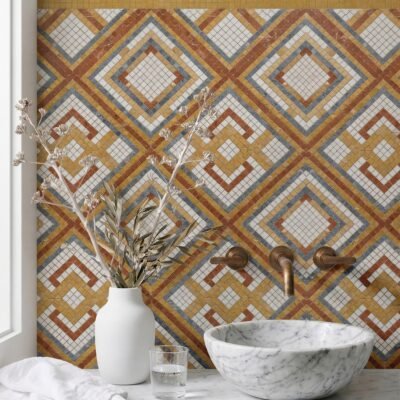 Geometric mosaic wall tile with layered diamond grid pattern in terracotta, ochre, blue, and ivory tones.