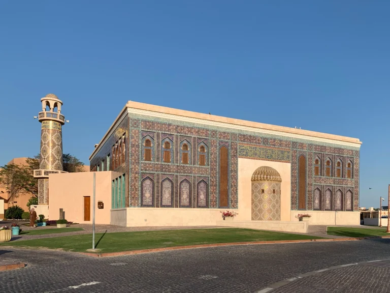 Islamic mosaic wall with geometric patterns, arches, and calligraphy inspired by traditional mosque architecture and heritage design.