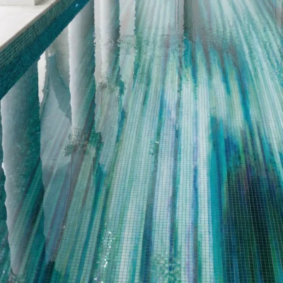 Teal Stream pool mosaic in teal and aqua tones inside a luxury indoor pool space.