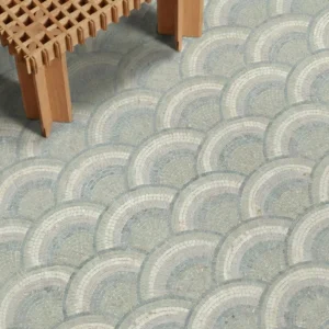 Soft arc mosaic floor design in pale blue, grey, and ivory tones with a repeating curved pattern.