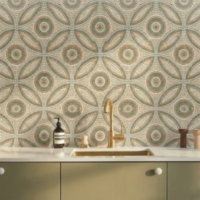Mosaic tile with circular floral pattern and petal shapes in sage green, beige, and ivory tones.
