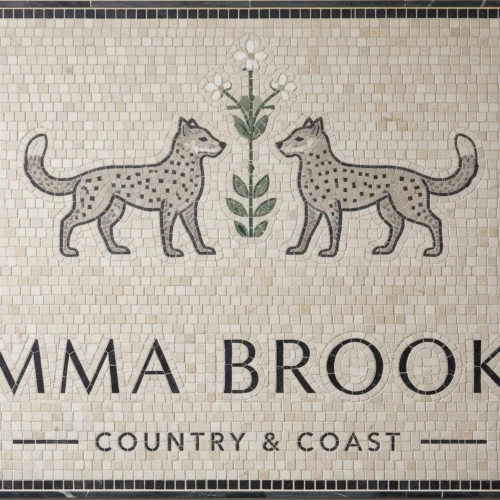 Mosaic tile panel with two leopards, floral motif, and “Emma Brooks Country & Coast” text.