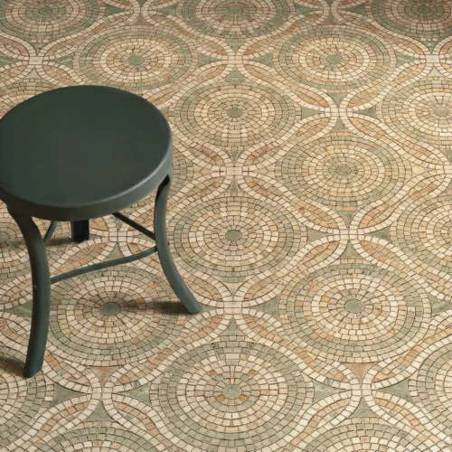 Geometric mosaic floor with circular medallion patterns in soft green and beige tones