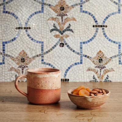mosaic tile pattern with ivory, blue, terracotta, and charcoal accents inspired by Mediterranean and Islamic artistry.