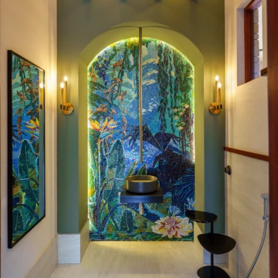 Luxury tropical bathroom mosaic wall with lush botanical artwork in blue and green tones, creating a serene spa-inspired interior.