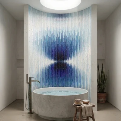 Blue ombre glass mosaic feature wall behind luxury bathtub with celestial gradient design for modern spa bathroom interiors.