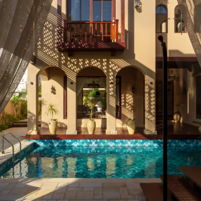 pool with geometric blue mosaic tiles in aqua and turquoise shades, creating a modern and elegant water effect.