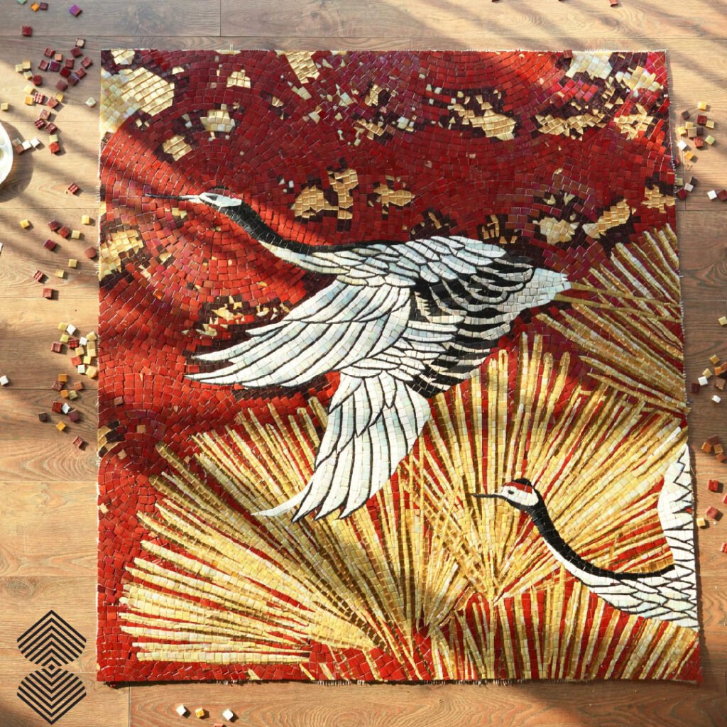 Handcrafted crane mosaic artwork featuring white soaring birds against rich crimson and radiant gold geometric textures.