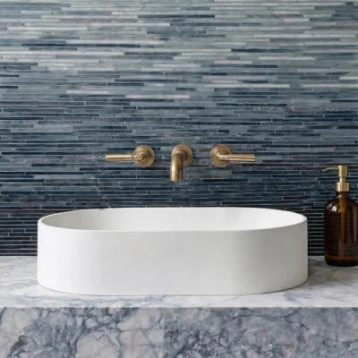 Blue ombre glass mosaic wall tile with layered grey and midnight blue linear patterns for modern luxury bathroom interiors.