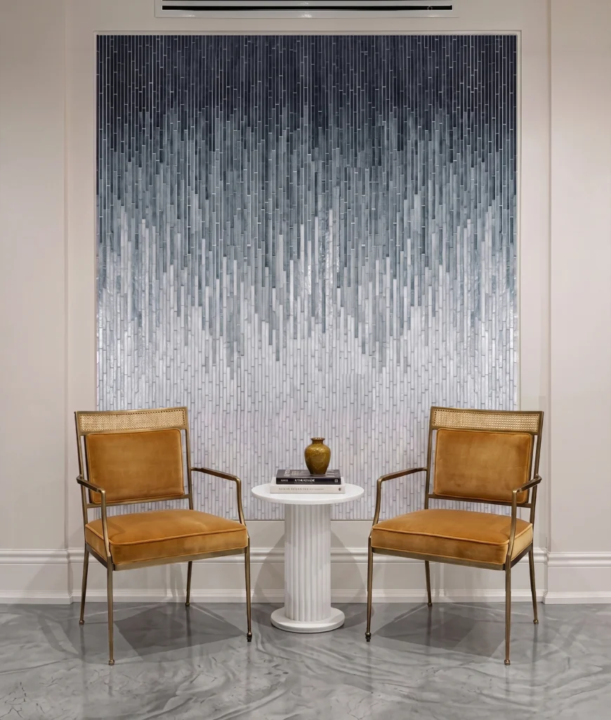 Vertical ombre glass mosaic wall with silver, grey, and charcoal gradient tones creating a luxury modern feature wall design.