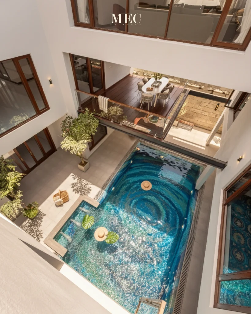 Luxury swimming pool with swirling blue mosaic design inspired by ocean currents, creating a dramatic whirlpool visual effect.