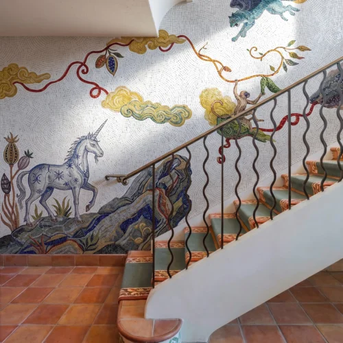 Handcrafted vertical mosaic mural featuring mythical winged creatures, clouds, vines, and artistic fantasy-inspired storytelling motifs.