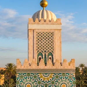 Handcrafted Moroccan geometric mosaic featuring intricate star patterns in emerald, turquoise, ivory, and gold inspired by Islamic architecture.