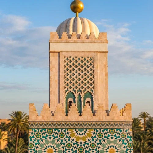Handcrafted Moroccan geometric mosaic featuring intricate star patterns in emerald, turquoise, ivory, and gold inspired by Islamic architecture.