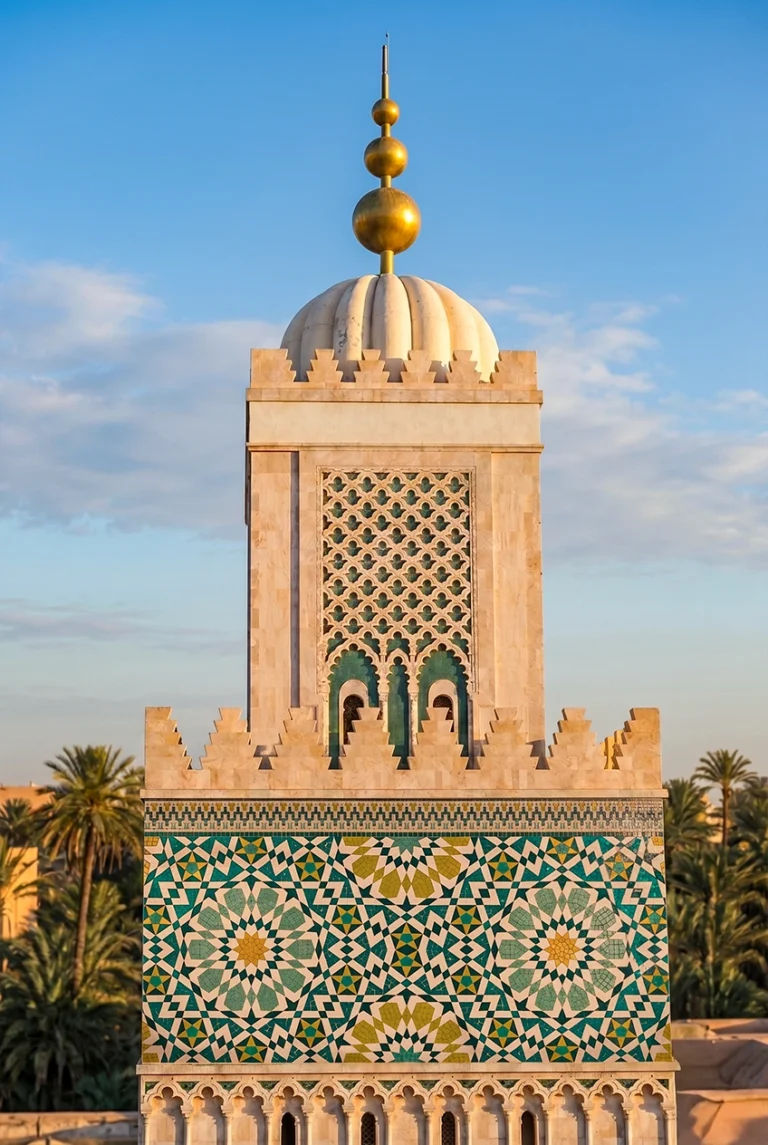 Handcrafted Moroccan geometric mosaic featuring intricate star patterns in emerald, turquoise, ivory, and gold inspired by Islamic architecture.