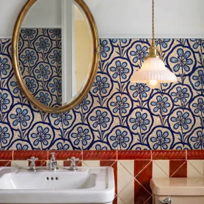 Handcrafted blue floral mosaic with repeating botanical pattern in natural stone and glass for elegant bathroom and kitchen feature walls.