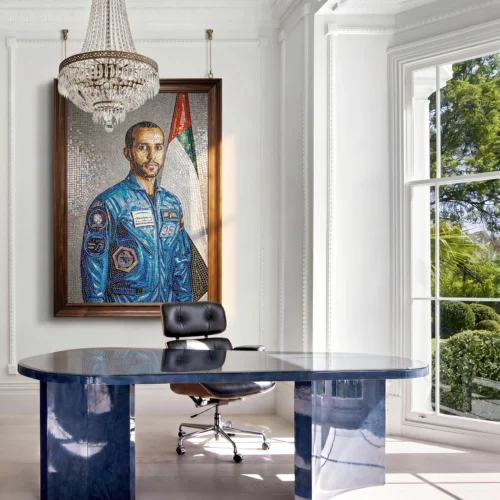 Handcrafted mosaic portrait of Major Hazzaa Al Mansoori in his astronaut suit with the UAE flag displayed in a contemporary executive office.