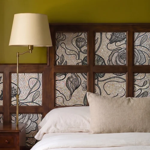 Handcrafted botanical mosaic with flowing floral motifs in ivory and charcoal tones integrated into a luxury wooden headboard design.