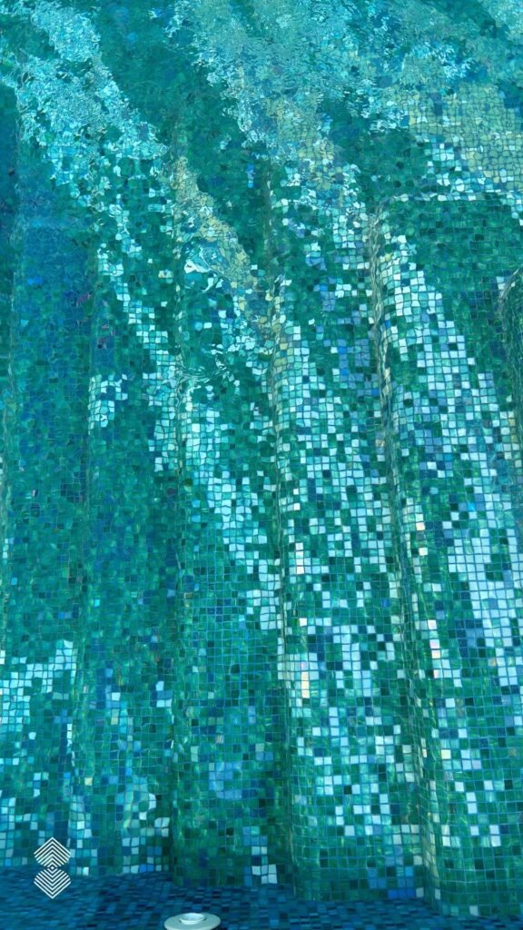 Custom mosaic pool design with flowing curves