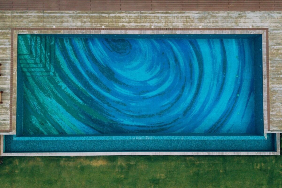 Swirling vortex mosaic pattern beneath pool water
