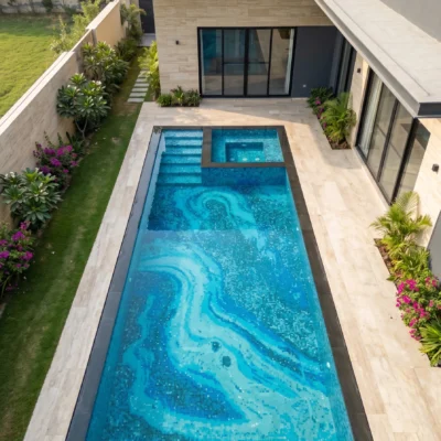 Luxury swimming pool featuring a handcrafted glass and marble mosaic with flowing blue abstract patterns beneath crystal-clear water.