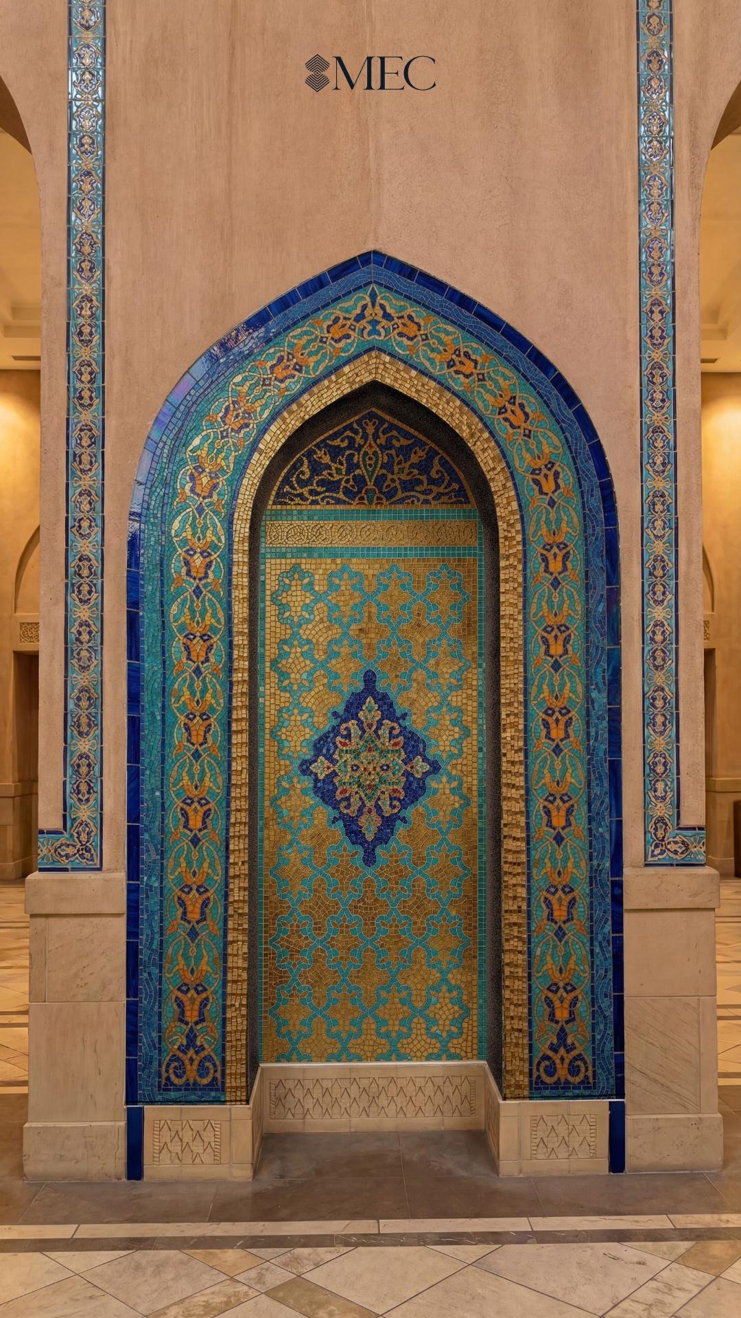 An ornate arched wall niche covered in intricate turquoise, dark blue, and gold arabesque mosaic tilework.
