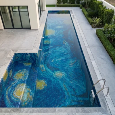 Handcrafted glass and marble pool mosaic featuring swirling blue celestial currents and golden accents created with mosaic tesserae.
