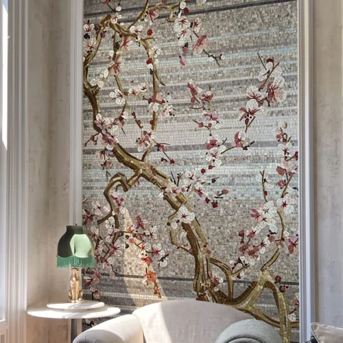 The Hanami Wall glass and marble mosaic featuring flowering branches with white and blush blossoms against a layered grey and pearl mosaic background