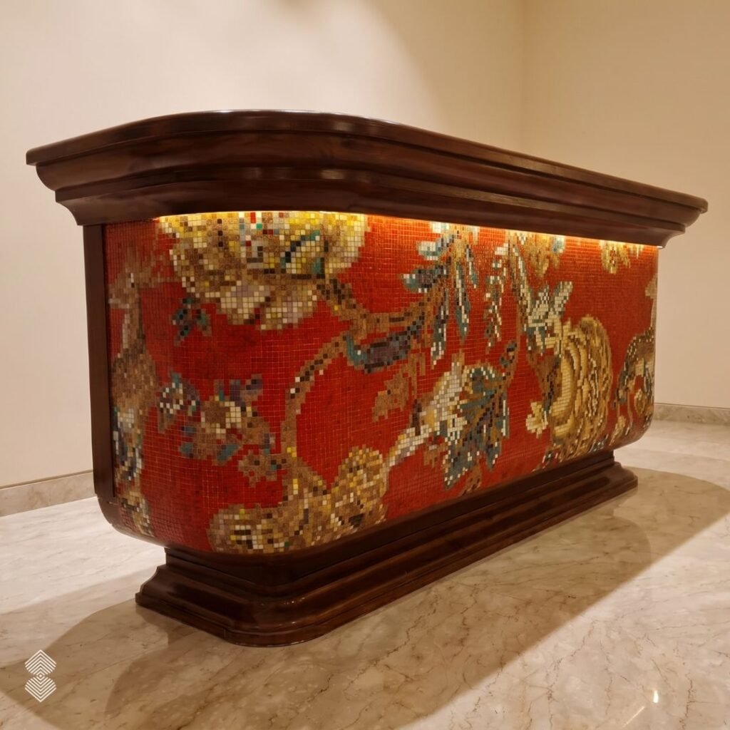 A wooden bar counter with under-counter lighting illuminating a rich crimson red mosaic front decorated with golden Chinoiserie floral patterns.
