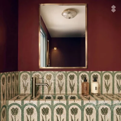 Handcrafted green tulip mosaic backsplash with repeating arched floral motifs across a luxury bathroom vanity wall.