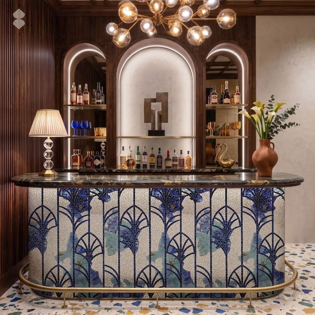 A luxurious bar area with a white and blue Art Deco fan-patterned mosaic covering the counter front under warm pendant lighting.