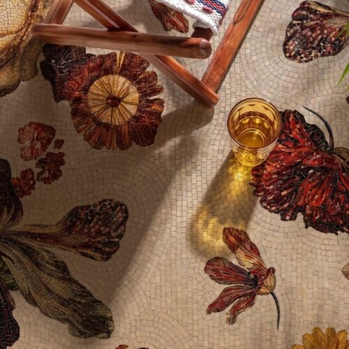 A floral walkway mosaic with rust and amber blossoms set into a pale stone ground.