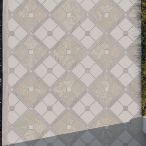 A diamond marble walkway mosaic in cream, beige and gray laid underfoot along a stone path.