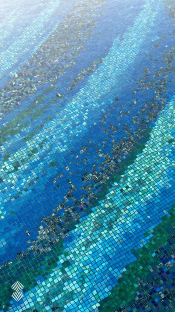 Close-up of blue, turquoise, and metallic square pixel mosaic tiles gleaming through rippling pool water.
