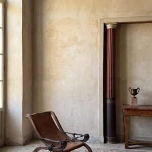 A Greek key floor mosaic with a radiating fan pattern in beige and terracotta stone tesserae.